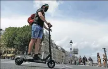  ?? LEWIS JOLY / ASSOCIATED PRESS ?? A man rides an electric scooter in central Paris on Aug 12.