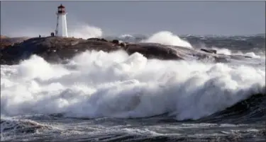  ?? ANDREW VAUGHAN — THE CANADIAN PRESS VIA AP ?? Waves pound the shore at Peggy’s Cove, Nova Scotia, Canada, on Friday.