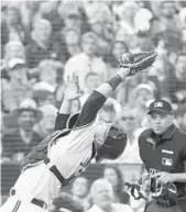  ?? NATHAN DENETTE/AP ?? Blue Jays catcher Danny Jansen makes a pop-up catch behind home plate. Fourteen years ago the rookie’s family hosted Baltimore’s Adam Jones when the Oriole was an A ball player in Wisconsin. They met up again for the first time Monday night in a big league game.