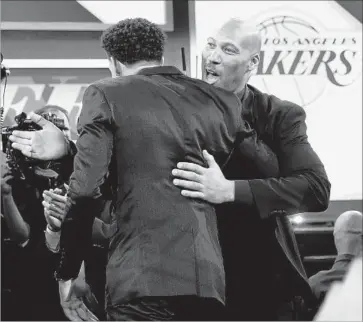  ?? Mike Stobe Getty Images ?? LaVAR BALL, right, embraces son Lonzo after the UCLA standout was chosen by the Lakers in the draft.