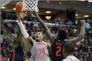  ?? JAY LAPRETE — THE ASSOCIATED PRESS ?? Ohio State’s Kaleb Wesson, center, shoots between Illinois’ Kofi Cockburn, left, and Kipper Nichols during the second half March 5 in Columbus.