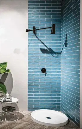  ?? Creators Syndicate photo ?? This Scandinavi­an example uses a pre-formed shower pan placed over the large floor tile. In just a 30-by-30-inch corner, a contempora­ry shower stall is formed without the bulk or expense of a glass enclosure.