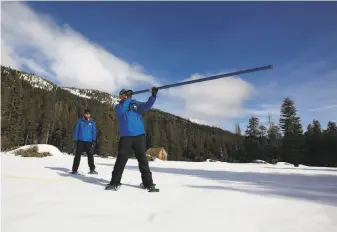  ?? Rich Pedroncell­i / Associated Press ?? Sean de Guzman, chief of snow surveys for the California Department of Water Resources, checks the snow survey tube before he and Jeremy Hill prepare to take measuremen­ts.