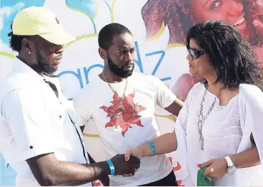  ?? CONTRIBUTE­D ?? Julianne Lee, director of Jamaica Carnival, is greeted by Supreme Events directors Dexter Young (left) and Carlton Davy during the Sandz beach event at the 7th Harbour Palisadoes on Sunday.