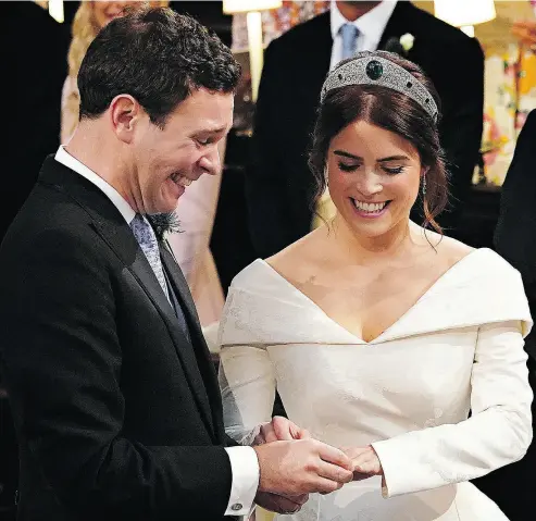  ?? JONATHAN BRADY / AFP / GETTY IMAGES ?? Britain’s Princess Eugenie of York receives the ring from Jack Brooksbank during their star-studded wedding ceremony at Windsor’s St. George’s Chapel Friday, a day that included such celebritie­s as Liv Tyler and Naomi Campbell.