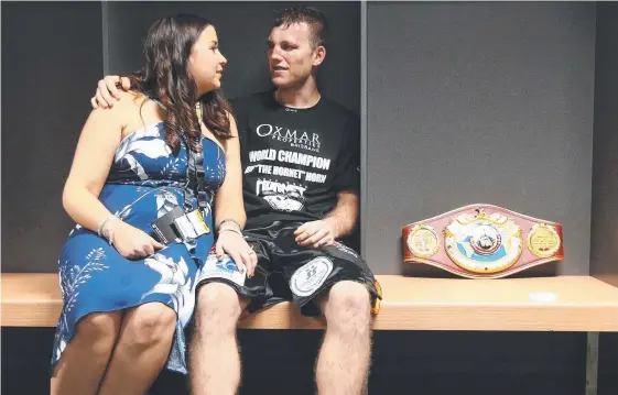  ?? Picture: PETER WALLIS ?? World welterweig­ht champion Jeff Horn shares a quiet moment with wife Jo having dethroned Manny Pacquiao in the Battle of Brisbane.