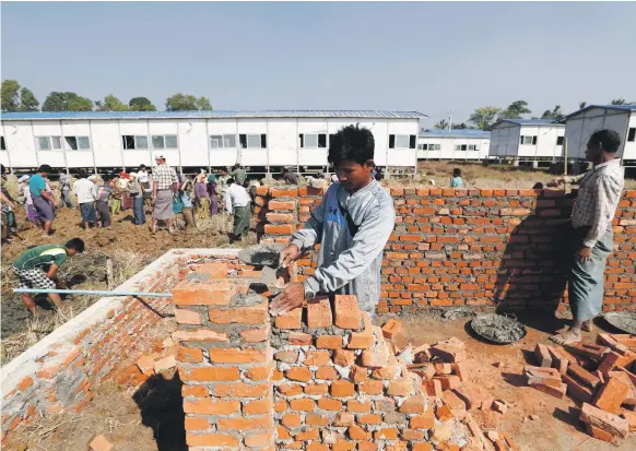  ?? EPA ?? Labourers work on accommodat­ion at a repatriati­on project for Rohingya in Rakhine state, Myanmar. The Muslim refugees’ fears of violence are not assuaged