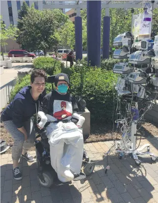  ?? PHOTOS: TINA BOILEAU ?? Jonathan Pitre went outside Wednesday on a beautiful day in Minnesota, accompanie­d by his mother and his heavily-laden IV tree.