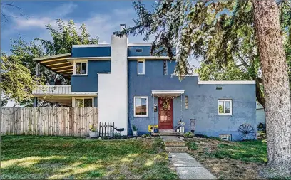  ?? CONTRIBUTE­D PHOTOS ?? The front of the home has a concrete walkway that leads to the front door with a covered stoop. The home has painted concrete block exterior and a chimney to the decorative fireplace in the great room. There are several mature trees around the home.