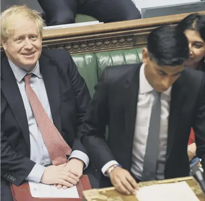  ??  ?? 0 Boris Johnson smiles as Chancellor Rishi Sunak delivers his 2020 spring budget statement