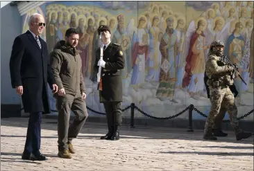  ?? PHOTOS BY EVAN VUCCI — THE ASSOCIATED PRESS ?? US President Joe Biden, left, walks with Ukrainian President Volodymyr Zelenskyy at St. Michaels Golden-Domed Cathedral during an unannounce­d visit, in Kyiv, Ukraine, Feb. 20, 2023.