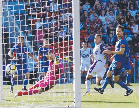  ?? Picture: AAP ?? ON TARGET: Perth’s Adam Taggart scores a first-half goal against Newcastle yesterday.