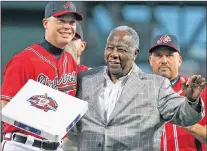  ?? AP PHOTO ?? In this Sept. 28, 2012, file photo, Atlanta Braves Hall of Famer Hank Aaron, right, presents Chipper Jones with third base during his tribute night at Turner Field in Atlanta.