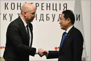  ?? KAZUHIRO NOGI - VIA THE ASSOCIATED PRESS ?? Ukraine’s Prime Minister Denys Shmyhal and Japanese Prime Minister Fumio Kishida during the Japan-Ukraine Conference for Promotion of Economic Growth and Reconstruc­tion at Keidanren Kaikan building in Tokyo on Monday.