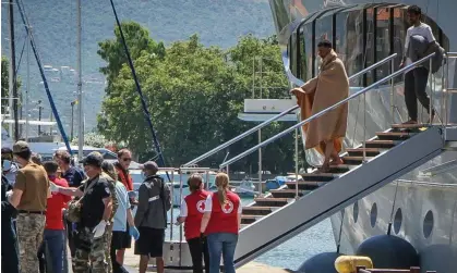  ?? Photograph: Eurokiniss­i/Reuters ?? Migrants arrive at the port of Kalamata in Greece, following a rescue operation after their boat capsized at open seat on Wednesday.