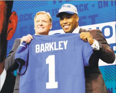  ?? David J. Phillip / Associated Press ?? Saquon Barkley, right, poses with commission­er Roger Goodell after being selected by the Giants during the first round of the NFL Draft on Thursday.