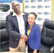  ?? CONTRIBUTE­D ?? Thelma Yong, deputy general manager, JN Small Business Loans, greets Garfield Ellis, marketing director of Digital Systems and Supplies, at the signing of a memorandum of understand­ing between the two companies recently.