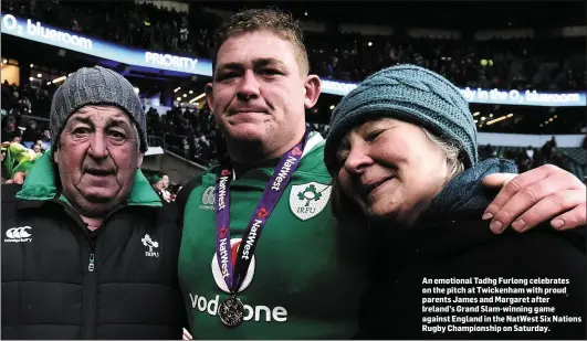  ??  ?? An emotional Tadhg Furlong celebrates on the pitch at Twickenham with proud parents James and Margaret after Ireland’s Grand Slam-winning game against England in the NatWest Six Nations Rugby Championsh­ip on Saturday.