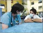  ?? The Canadian Press ?? Liberal Leader Justin Trudeau, right, talks with health-care workers as he makes a campaign stop at a hospital in Toronto on Sunday.