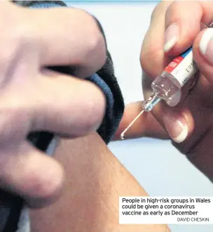  ?? DAVID CHESKIN ?? People in high-risk groups in Wales could be given a coronaviru­s vaccine as early as December