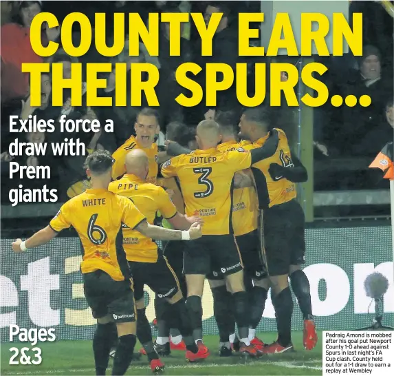  ??  ?? Padraig Amond is mobbed after his goal put Newport County 1-0 ahead against Spurs in last night’s FA Cup clash. County held out for a 1-1 draw to earn a replay at Wembley