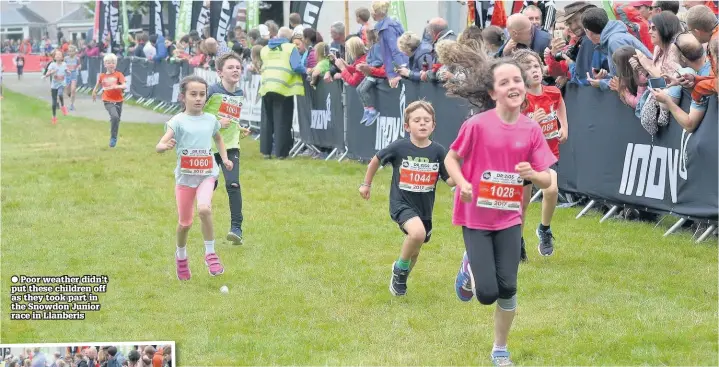  ??  ?? ● Poor weather didn’t put these children off as they took part in the Snowdon Junior race in Llanberis