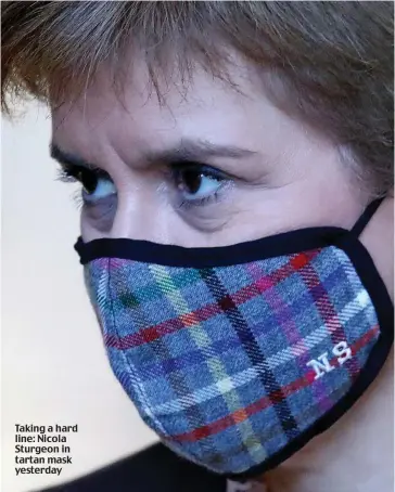 ??  ?? Taking a hard line: Nicola Sturgeon in tartan mask yesterday