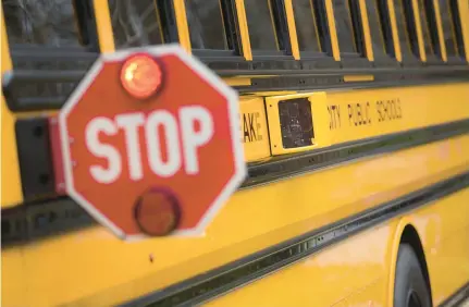  ?? L. TODD SPENCER/STAFF ?? A Chesapeake city school bus with its stop-arm extended is seen at Chesapeake Central Library in 2020.