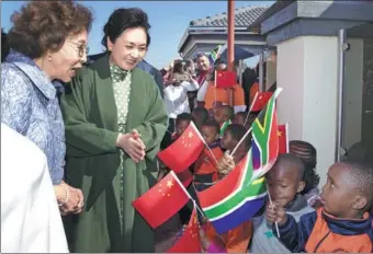  ?? WANG YE / XINHUA ?? Peng Liyuan, the wife of President Xi Jinping and a UNESCO special envoy, and South African first lady Tshepo Motsepe visit Uthando Day Care Preschool in a suburb of Pretoria, South Africa, on Tuesday.