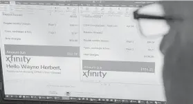  ??  ?? Herbert looks at the past two months of his Comcast Xfinity bills, which jumped to $104.25 from $64.06 and prompted an annual phone call.