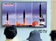  ?? LEE JIN-MAN/AP PHOTO ?? People watch a TV screen showing a local news program reporting about North Korea’s missile launch at Seoul Train Station in Seoul, South Korea, on Wednesday.