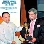  ??  ?? Mohamed Anverally, Chairman – Anverally & Sons, receiving the award from Minister of Plantation Industries Navin Dissanayak­e
