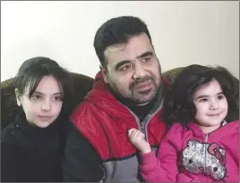  ?? AP PHOTO ?? Syrian refugee Mahmoud Mansour, 43, is shown with his daughters Ruba, 9, and Sahar, 3. Mansour, who has been undergoing vetting for resettleme­nt to the U.S. for the past year, says he was devastated by President Donald Trump’s travel ban and remains...