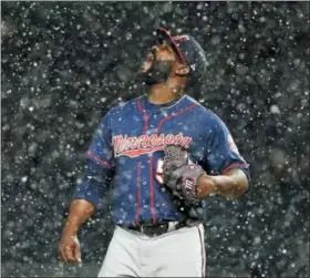  ?? GENE J. PUSKAR — THE ASSOCIATED PRESS ?? Minnesota Twins relief pitcher Fernando Rodney stands on the mound during a snow squall in the ninth inning of the team’s baseball game against the Pittsburgh Pirates in Pittsburgh, Wednesday. The Twins won 7-3.