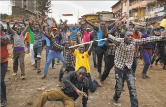  ?? Ben Curtis / Associated Press ?? Protesters in Nairobi celebrate after hearing details from a news conference that they interprete­d as meaning opposition leader Raila Odinga will become president.