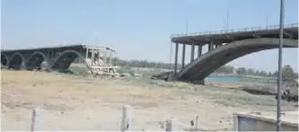  ??  ?? A destroyed bridge in Mosul.