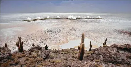  ?? Amazing Escapes via New York Times ?? The Kachi Lodge atop the Uyuni Salt Flats in the Altiplano region of Bolivia. The Swiss-based outfitter was tapped by the indigenous Jirira community to build the sustainabl­e tented camp.
