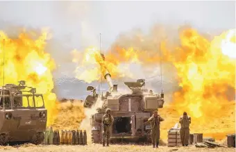  ?? YONATAN SINDEL/ASSOCIATED PRESS ?? An Israeli artillery unit fires Wednesday toward targets in the Gaza Strip along the Israel-Gaza border.