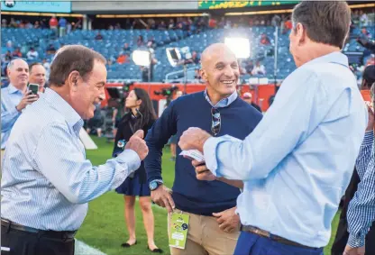  ?? Tim Hiatt / NBCUnivers­al ?? NBC Sports Chairman Pete Bevacqua, center, talks with Sunday Night Football announcer Al Michaels, left, and SNF analyst Cris Collinswor­th, right, at the NFL kickoff game at Soldier Field in Chicago on Sept. 5, 2019.