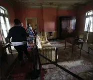  ?? GERALD HERBERT—ASSOCIATED PRESS ?? In this July 14, 2017file photo, visitors walk through the Whitney Plantation in Edgard, La. The Whitney, which documents slavery at a pre-Civil War plantation near New Orleans, draws tens of thousands of visitors annually and is known for discussing topics that other tourist plantation­s ignore.