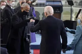  ?? THE ASSOCIATED PRESS ?? President-elect Joe Biden bumps fists with former President Barack Obama during Biden’s inaugurati­on, Wednesday.