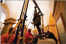  ?? (AP/Office of Governor of Virginia/Jack Mayer) ?? Workers on Monday remove the statue of Confederat­e Gen. Robert E. Lee from the National Statuary Hall Collection in Washington.