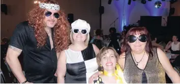  ?? —photo Vicky Charbonnea­u ?? Hundreds had donned their boots, big wigs, glasses and psychedeli­c trousers, last Friday, for the Club Optimiste’s annual disco night. In addition to playful and enjoyable times, the last 10 editions of the festive gathering have now helped raise no...