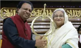  ??  ?? The author presenting PM Sheikh Hasina with Dr Kalam Smriti Internatio­nal Excellence Award.
