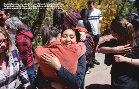  ?? OLIVIA HARLOW/THE NEW MEXICAN ?? Hannah Laga Abram, a junior at the Waldorf School, hugs Cyana Calladitto from the Santa Fe Indian School at the close of a student-organized rally on April 20.