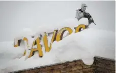  ??  ?? Security personnel guard the rooftop of a hotel near the Davos Congress Centre ahead of the 2018 World Economic Forum annual summit.