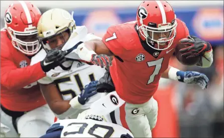  ?? / Joshua L. Jones-Athens Banner-Herald ?? Georgia running back D’Andre Swift (7) carries the ball against Georgia Tech during Saturday’s game in Athens, Ga.