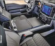  ??  ?? THE CENTER console is able to extend into a broad workspace for the operator’s laptop or notebook.