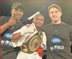  ??  ?? POWER PUNCH: Simpiwe Konkco, centre, flanked by assistant trainer Vusi Mtolo, left, and trainer Colin Nathan after the boxer defeated Filipino Lito Dante in their IBO mini-flyweight title clash Picture: GALLO IMAGES