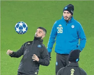  ?? PAUL ELLIS AFP/GETTY IMAGES ?? Napoli striker Lorenzo Insigne, left, attends a training session at Anfield stadium in Liverpool on Monday. The teams meet Tuesday, with Napoli in first place in Group C and Liverpool in third.